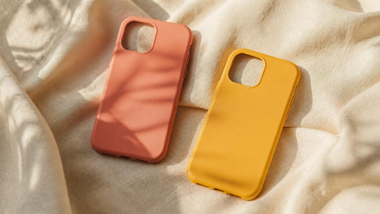 LITERALLY NEED phone cases arranged on cream linen